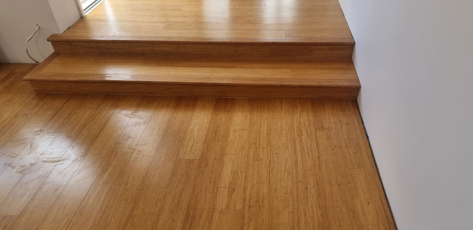 Close-up detail of Champagne bamboo flooring planks with natural grain pattern