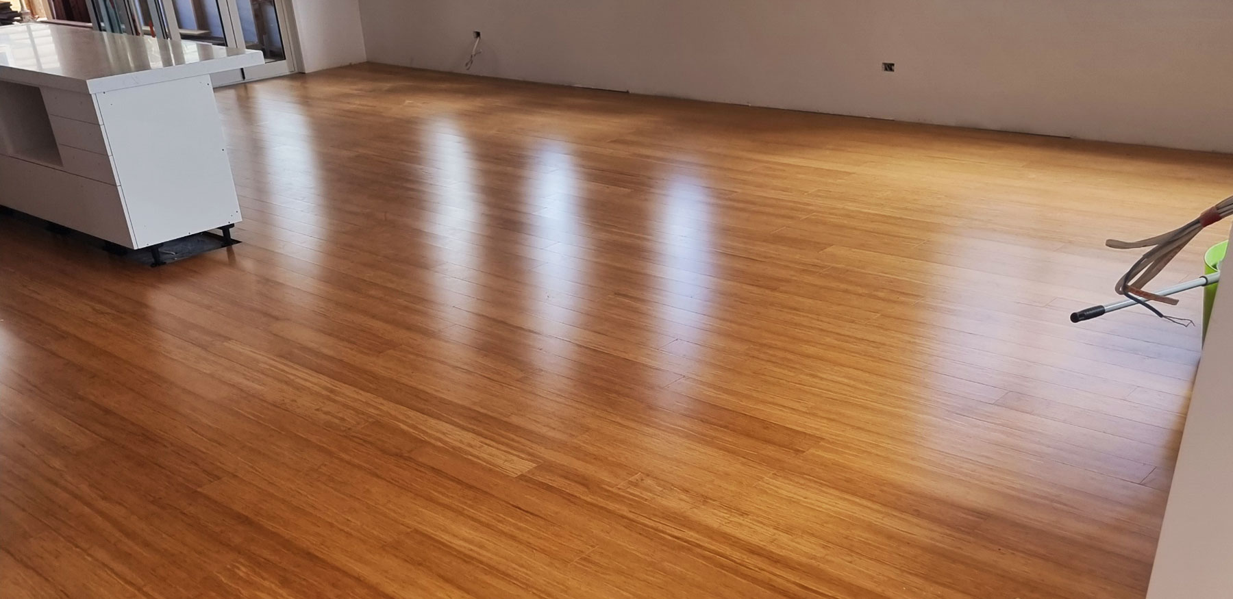 Champagne bamboo flooring in an open-plan living area with natural light